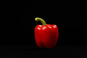 Capsicum bell pepper red yellow on black background