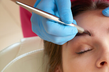 Professional eyebrow correction in a beauty salon