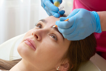 Professional eyebrow correction in a beauty salon