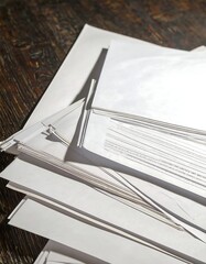 Stack of Papers on Wooden Table