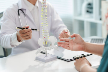 Patient consulting doctor about chronic back pain.