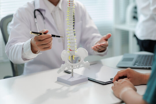Patient consulting doctor about chronic back pain.