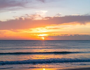 Obraz premium Vibrant sunset over calm ocean waves at beach