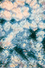 Abstract painted background with swirling blue, white, and pink brushstrokes creating a dreamlike floral texture