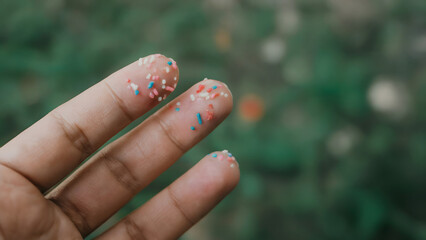 Playful sprinkles adorn fingertips, creating a whimsical, sweet treat moment