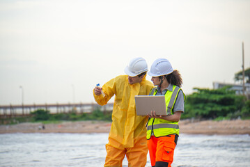 Scientists and assistants are collecting water samples from natural sources to analyze contaminants from water discharged from industrial plants.