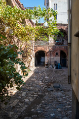 Historic Ottoman caravanserai inn courtyard with stone arches and workshops in Istanbul Turkey showing traditional architecture and cultural heritage site