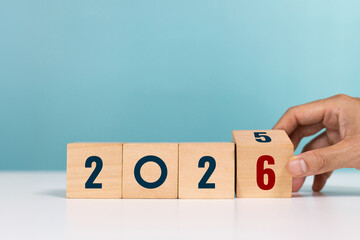 New year 2026 countdown, goal planning, Loading year 2026, Merry christmas and happy new year. Hand flip wooden cube for countdown to 2026