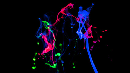 Obraz premium Photo of vibrant neon ink splashes and trails in shades of blue, pink, and green against a stark black background