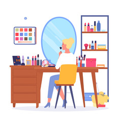 Woman applying makeup at a vanity table.