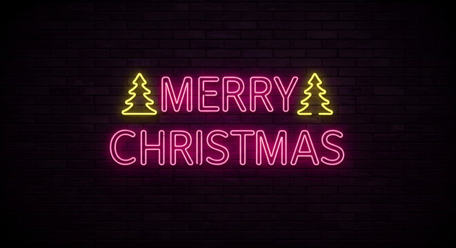 Vibrant neon 'Merry Christmas' sign glows brightly on a dark brick wall, perfect for festive celebrations