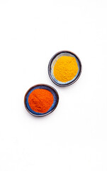Food, cooking, spices background, dried ground chili pepper and turmeric, white copy space, top view
