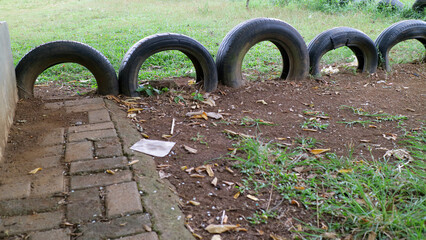 Used tires as garden border in grassy area