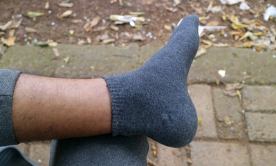 Person in Gray Socks Relaxing Outdoors