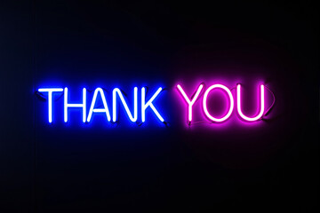 Neon thank you sign in glowing blue and pink colors on dark background, creative style for gratitude or appreciation concept, night ambiance.. Ai generative