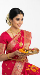 young indian woman holding oil lamp on diwali festival at home