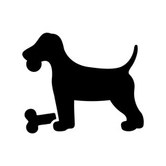 Silhouette of a dog holding a bone, standing near another bone