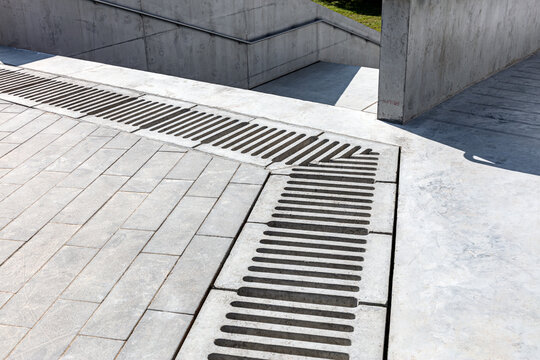 sewer grate for drainage system on concrete stairway. urban architecture detail. - Powered by Adobe