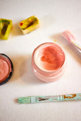 Creative flat lay with watercolor paints, brushes, palette, and color swatches on paper. Artistic composition for design, creativity, craft, and art concept backgrounds