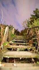 Old wooden steps leading up to a night sky