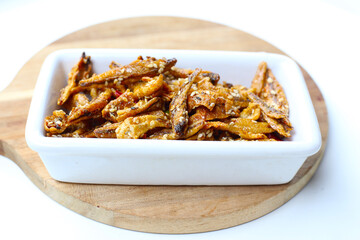 Crispy fried anchovies with sesame, dried chili, green peas, and herbs