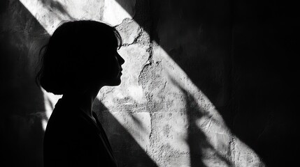 Silhouette of a Woman Against a Wall with Light Streaks
