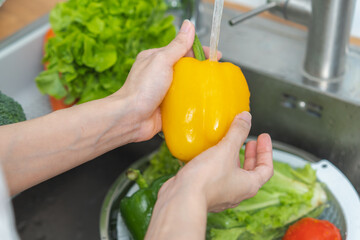 people washing raw vegetables at sink in the kitchen prepare ingredient for cooking