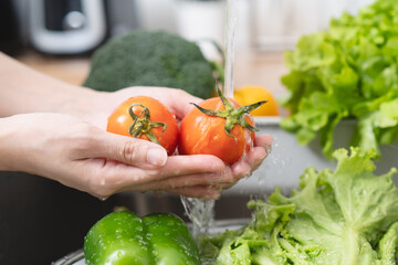 Fototapeta na wymiar people washing raw vegetables at sink in the kitchen prepare ingredient for cooking
