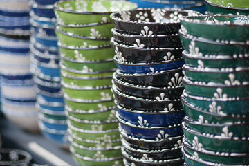 Colorful ceramic bowls displayed at a market stall
