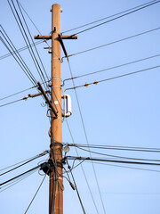 Wooden Utility Pole with Electricity Power lines and High Voltage Connections