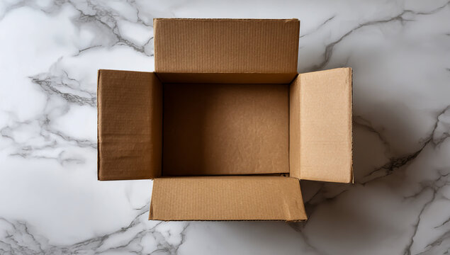 Overhead view of an empty open cardboard box on a marble patterned surface - Powered by Adobe