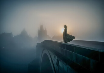 A lone woman in a flowing dress stands on a stone bridge shrouded in thick fog, with the silhouette of a castle visible in the distance as the sun attempts to break through the atmospheric haze