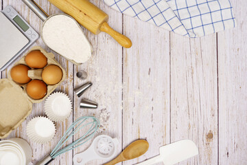 Homemade Dough Recipe (Eggs, flour, milk, sugar) and wooden kneading dough on a wooden table, view from above	
