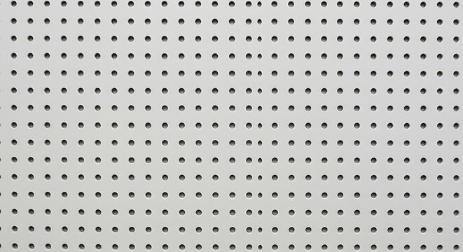 Structured perforation arrangement on a board background exhibiting orderly array and pattern