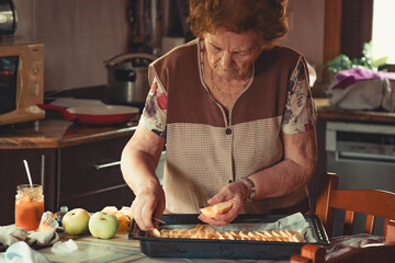 senior woman preparing a dessert or cake at home