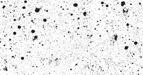 Dense black speckled dotted pattern on white surface abstract textured effect