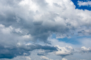 Dark cumulus clouds in the blue sky.