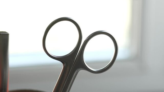metal scissors are standing in a glass