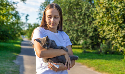 Woman holding a cat. Woman is allergic to cats. Allergy to cat fur.