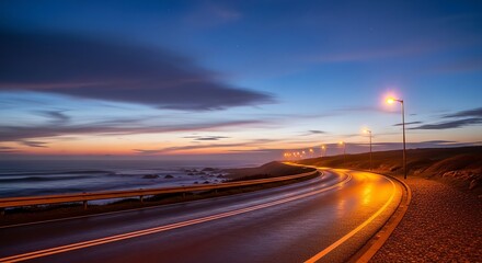 Winding Coastal Road at Dusk: Illuminated Pathway, Serene Sunset Sky.