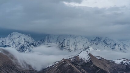 Heavy clouds over a snow covered mountain range
