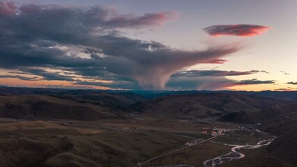 Tornado-like cloud formation over a valley
