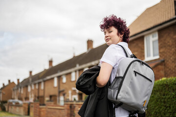 Teen age school girl going back to school wearing school uniform