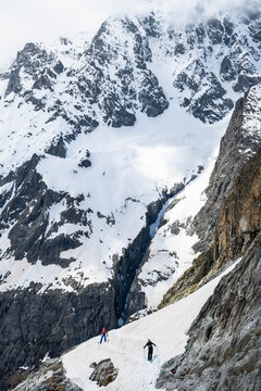 Skiers descending the Glacier Blanc in the Alps.