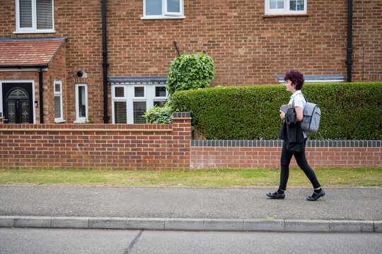 Teen age school girl going back to school wearing school uniform