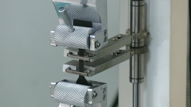 Universal Electromechanical Testing Tensile Machine.  High Technology and Accuracy of Automatic Tensile strength testing machine with product during testing for industrial