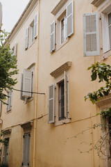 Facade of Yellow Building with Shuttered Windows