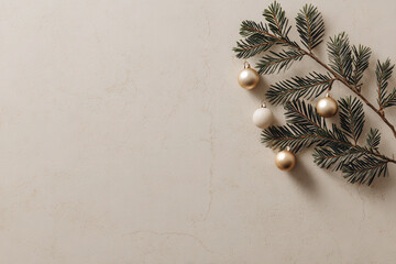 Sprig of evergreen with gold and white baubles lies on marble surface, creating minimalist and elegant holiday decoration. neutral tones and simple design evoke sense of calm and sophistication