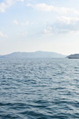 Panorama of Rhodes Island from the sea. Beautiful sea landscape. Holidays and travel to Greece. Motorboating during vacation. Boat rental. Summer vacation at sea. Tourist boat trip. 