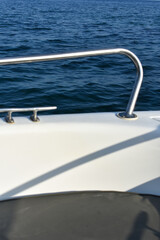 Obraz premium Close-up of a boat on the sea. Driving motorboat on holiday. Boat rental. Rhodes, Greece. Motorboat parts. Summer vacation at the sea. Tourist boat trip.
